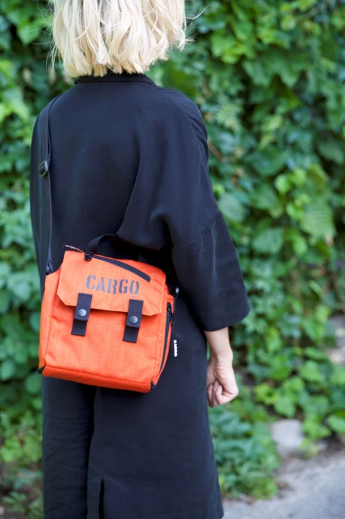 kobieta z elegancką pomarańczową listonoszką mini plecak z cordury cargo by owee na tle roślin