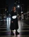 CARGFObyOWEErowrbikeFull-body nighttime shot on a city street. stands on a wet crosswalk_ illuminated by harsh direct flash. Strong contrast_ cinematic mood_ dark urban background with blurred building lights_ traffic si.webp